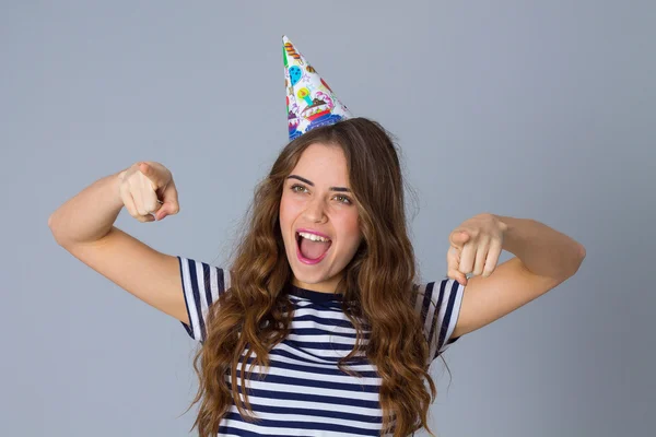 Woman in celebration cap holding pointing fingers in front of he — Stockfoto