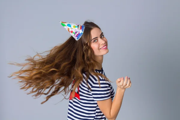 Woman in celebration cap whirling — Stock Photo, Image