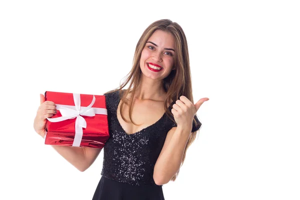 Woman holding a present and showing thumb up — Stock Photo, Image