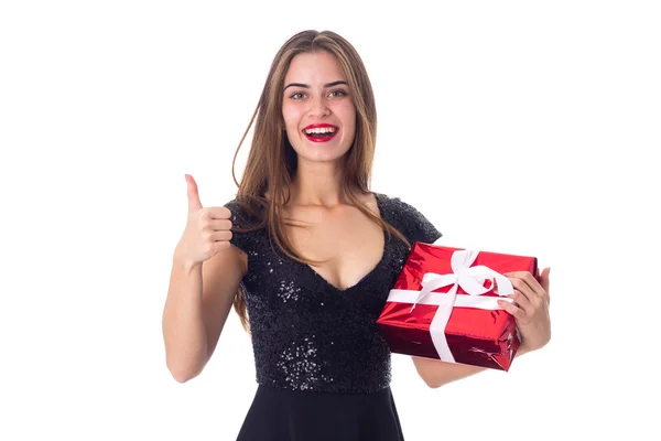 Woman holding a present and showing thumb up — Stock Photo, Image