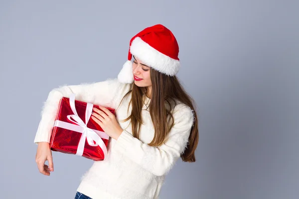 Kırmızı Noel şapka holding kadında sunar — Stok fotoğraf