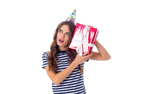 Woman in celebration cap holding a present — Stock Photo, Image