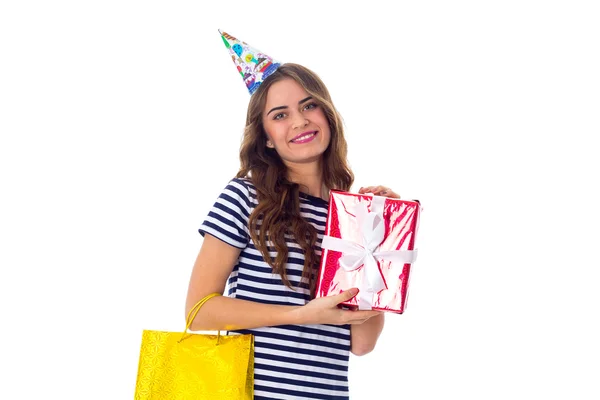 Woman in celebration cap holding presents — Stock Photo, Image