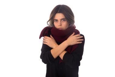 Woman in scarf hugging herself