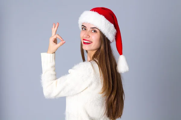 Woman in red christmas hat showing okay — Stock Photo, Image