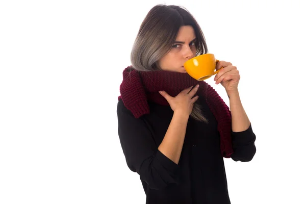 Woman drinking from yellow cup — Stock Photo, Image