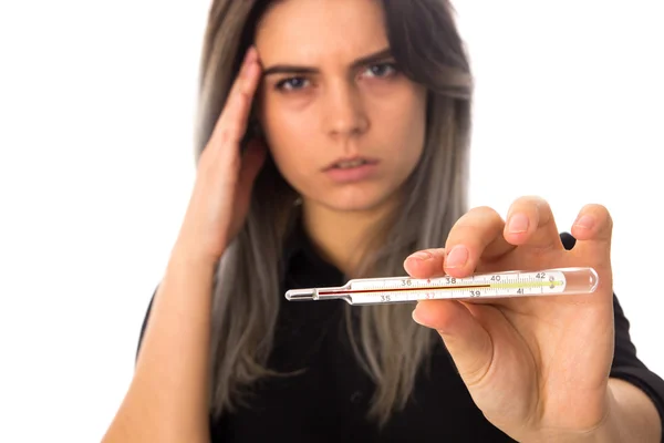 Mujer con dolor de cabeza sosteniendo un termómetro —  Fotos de Stock