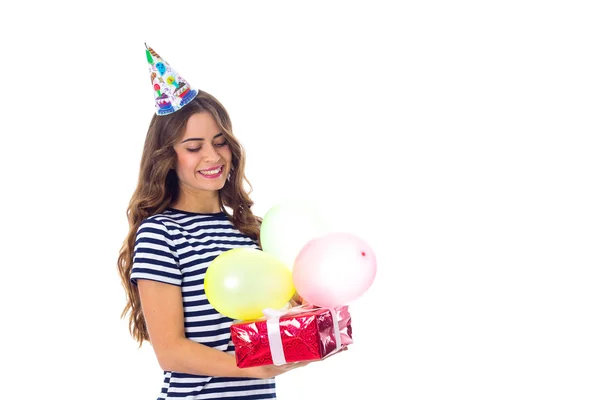 Woman holding present and balloons — Stock Photo, Image