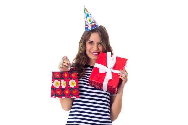 Woman in celebration cap holding presents — Stock Photo, Image