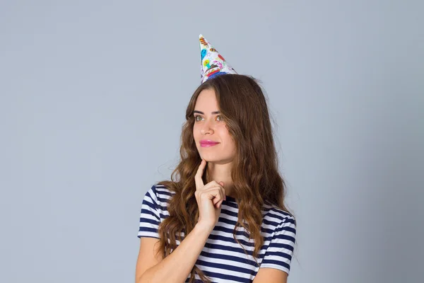 Woman in celebration cap thinking — Φωτογραφία Αρχείου
