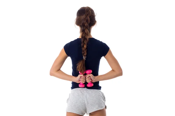Mujer sosteniendo dos pesas rosadas —  Fotos de Stock
