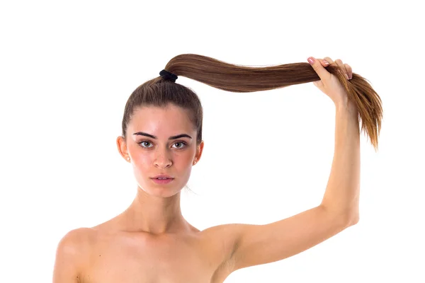 Woman holding her long ponytail — Stock Photo, Image