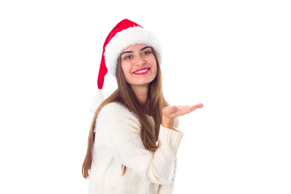 Woman in red christmas hat holding something — Stock Photo, Image