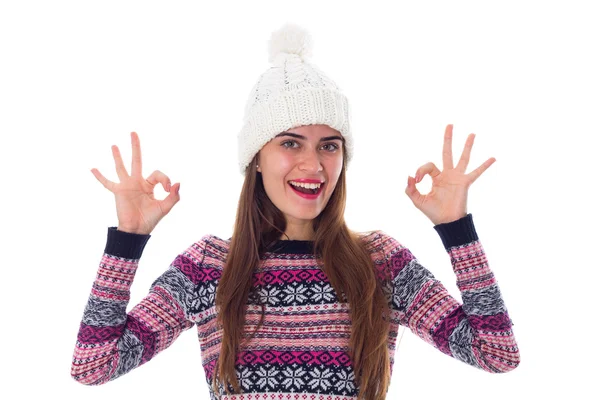 Woman in sweater and white hat showing okay — Stockfoto