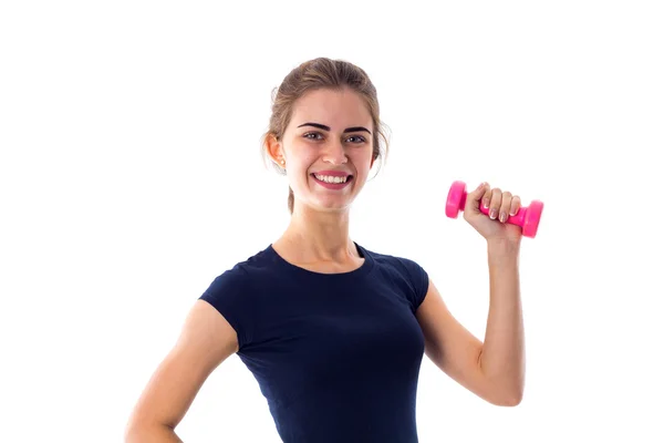 Woman holding a pink dumbbell — ストック写真