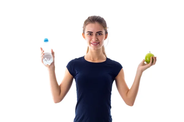 Woman holding apple and water — Stock Photo, Image
