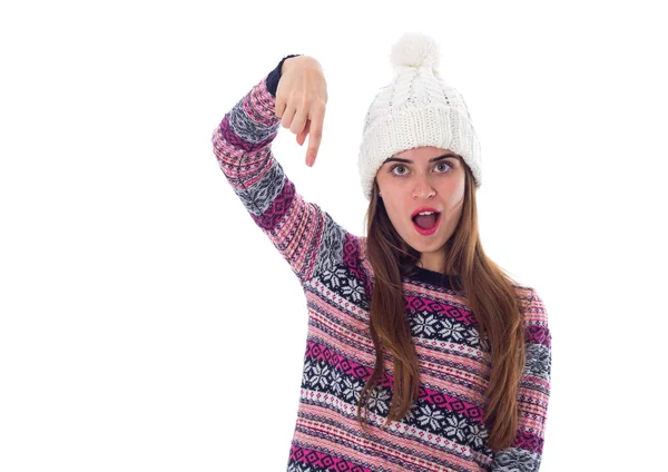 Woman in sweater and white hat pointing down — Stock Photo, Image