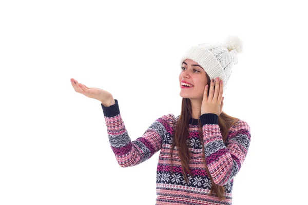 Woman in sweater and white hat holding something — Stock Photo, Image