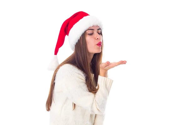 Woman in red christmas hat sending air kiss — Stock Photo, Image