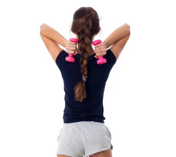 Mujer sosteniendo dos pesas rosadas —  Fotos de Stock