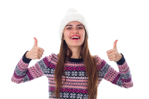 Woman in sweater and white hat showing thumbs up — Stockfoto