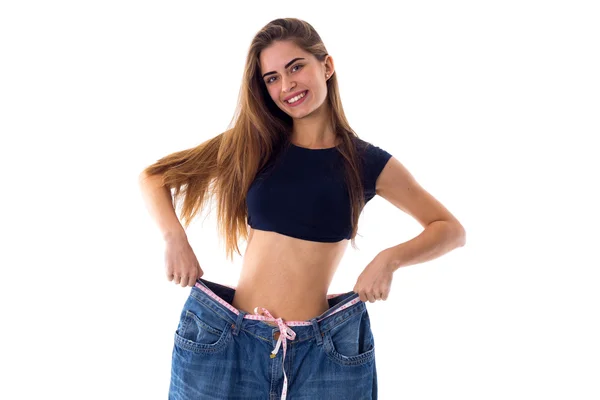 Woman wearing jeans of much bigger size — Stock Photo, Image