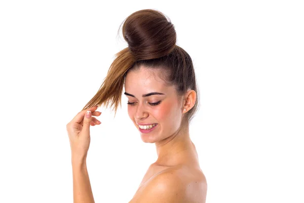 Woman with hair in a bun smiling — Stockfoto