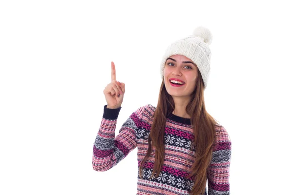 Woman in sweater and white hat pointing up — Stock Photo, Image