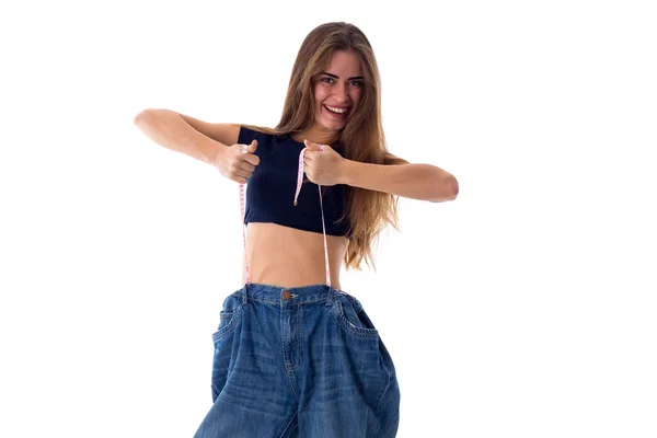 Mulher usando jeans de tamanho muito maior — Fotografia de Stock