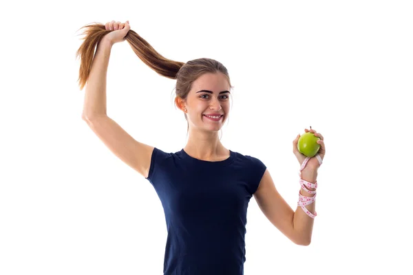 Woman with centimeter holding an apple and her hair — Stock Photo, Image