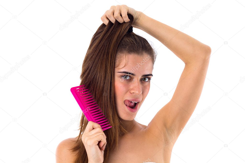Young woman combing her long ponytail