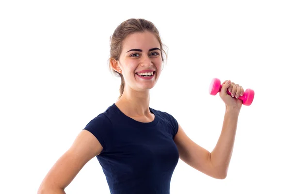 Woman holding a pink dumbbell — Stock fotografie