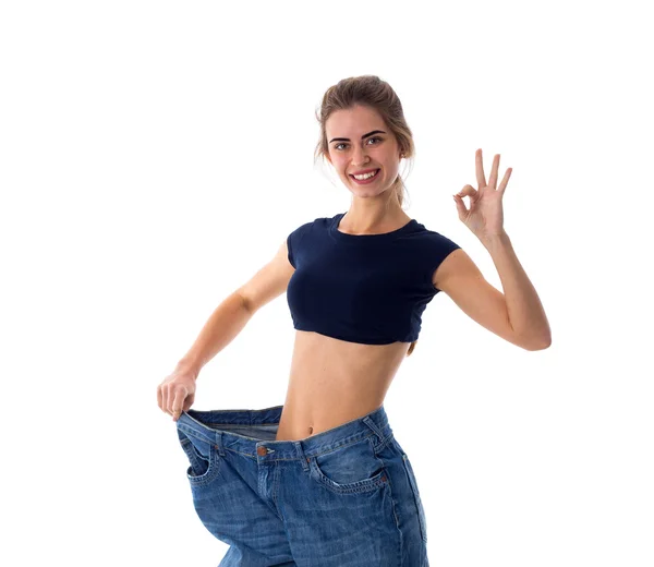 Woman wearing jeans of much bigger size — Stock Photo, Image