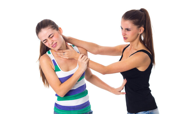 Young woman keeping another womans throat