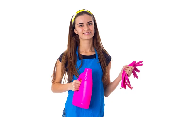 Woman in apron holding gloves and detergent — Stock Photo, Image