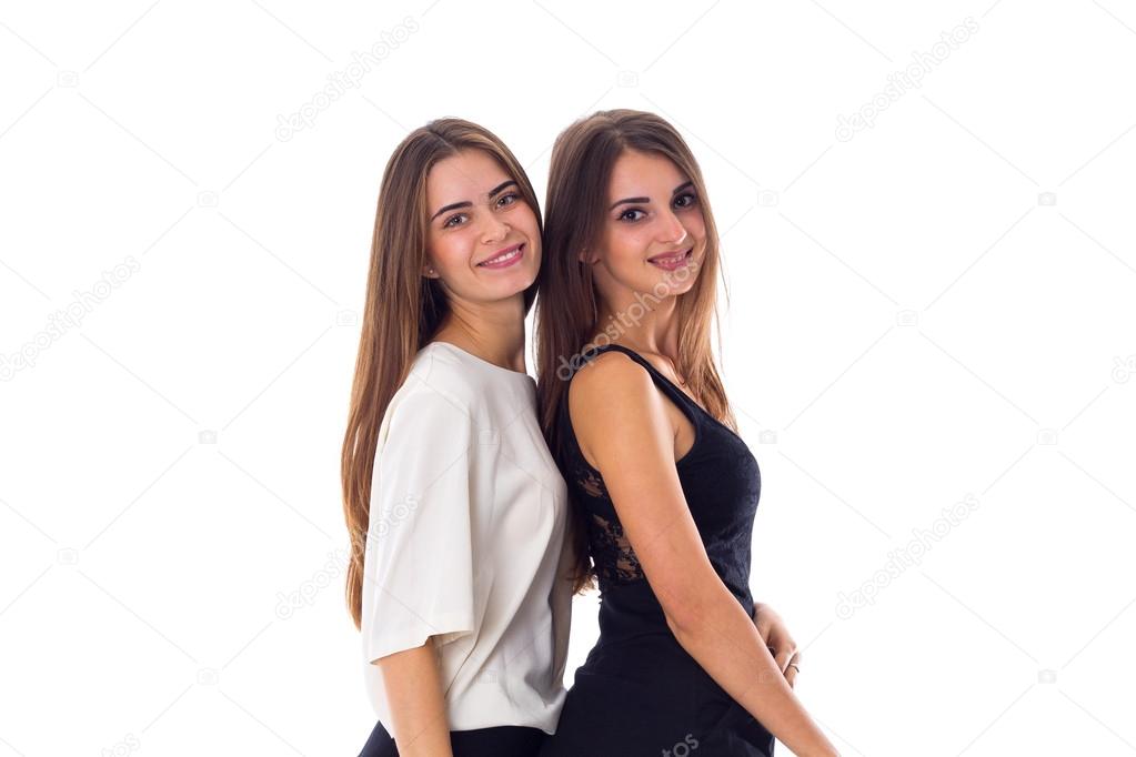Two young woman standing and smiling