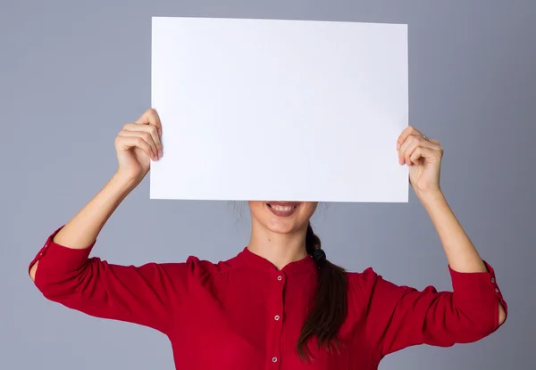 Woman holding white sheet of paper Royalty Free Stock Photos
