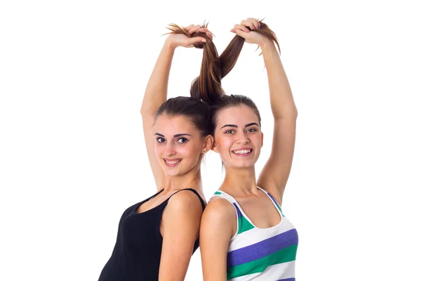 Dos mujeres jóvenes sosteniendo su cabello Imagen De Stock