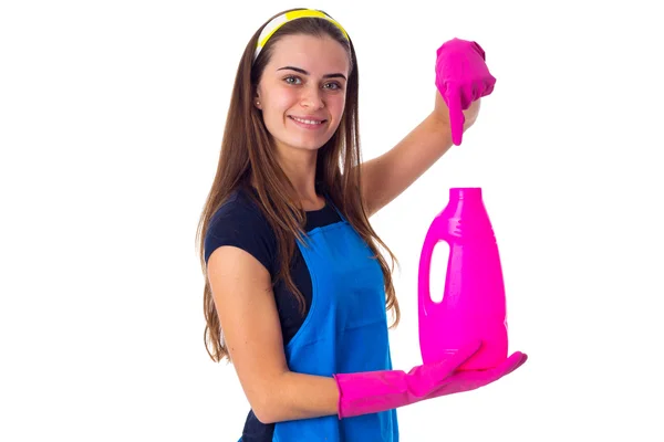 Woman in apron holding a detergent — Stock Photo, Image