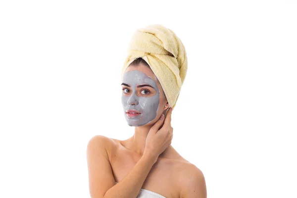 Жінка з рушником на голові і косметичною маскою на обличчі — стокове фото