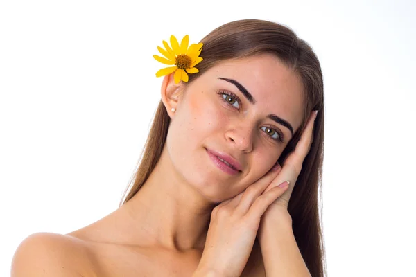 Mladá žena se žlutou květinou ve vlasech — Stock fotografie