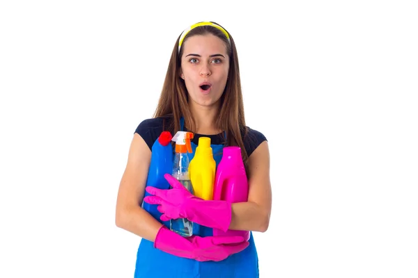 Woman in apron holding a detergents — Stock Photo, Image