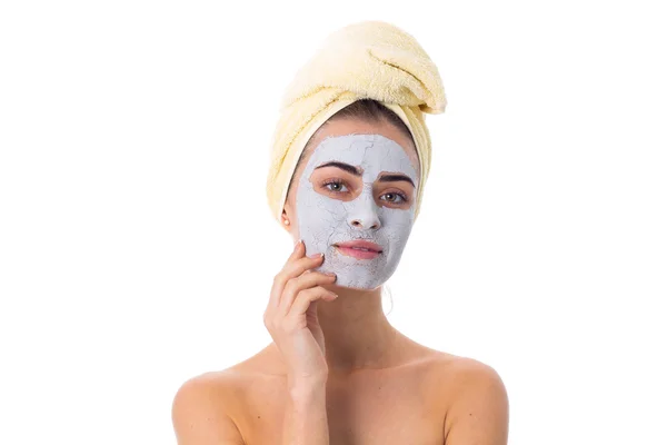 Woman with towel on her head and cosmetic mask on her face — Stock Photo, Image