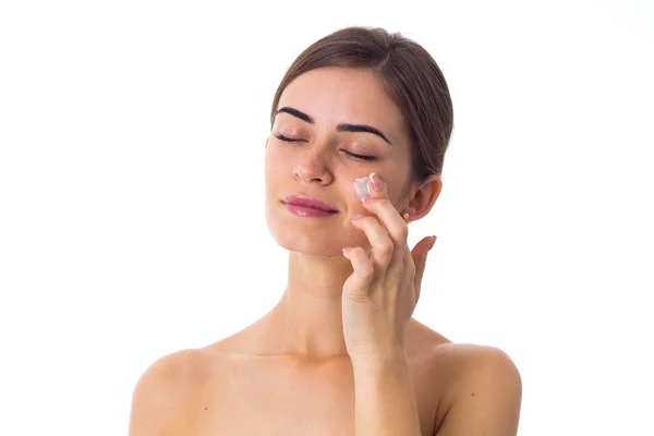 Young woman using cream — Stock Photo, Image