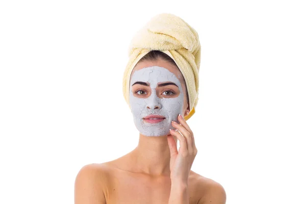 Femme avec serviette sur la tête et masque cosmétique sur le visage — Photo