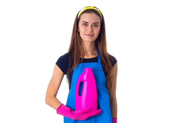 Woman in apron holding a detergent — Stock Photo, Image