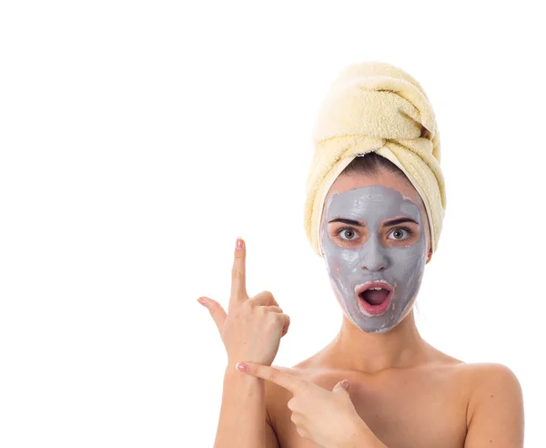 Woman with towel on her head and cosmetic mask on her face — Stock Photo, Image