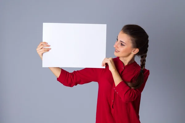 Woman holding white sheet of paper — Stock Photo, Image