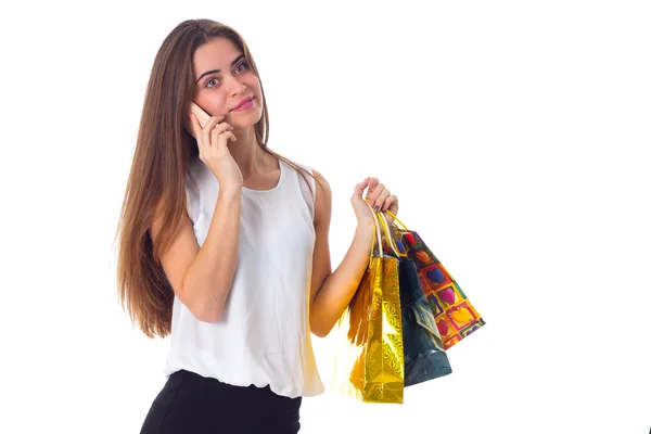 Mulher com smartphone e sacos de compras — Fotografia de Stock