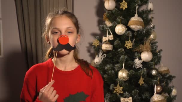 Tiener meisje met Kerstmis rekwisieten masker met de rode neus — Stockvideo